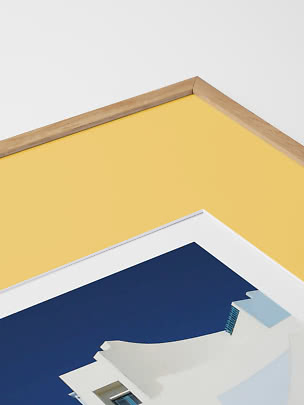 Close-up of framed print with light wood frame and yellow background