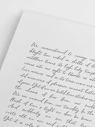 Nærbillede af hvidt papir med håndskrevet tekst i sort kalligrafi