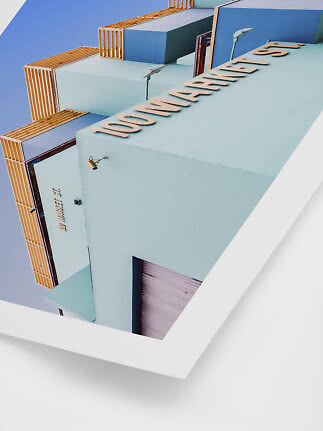 Poster showing an angled view of a pastel blue building facade with 100 Market St. lettering.