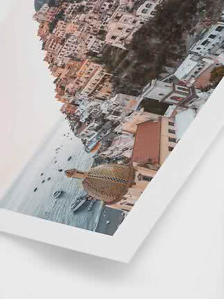 Framed photo of a coastal town with church dome, boats, and pastel buildings by the sea