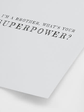 White poster with black text: “I’m a brother, what’s your superpower?”
