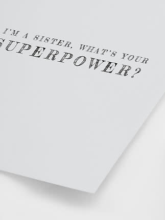 White poster with black text: “I’m a sister, what’s your superpower?”