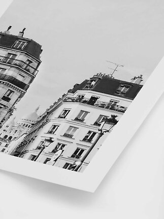 Black-and-white print of Paris buildings with Sacré-Cœur in the background