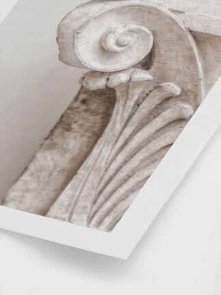 Close-up of a classical column capital with spiral volute in beige tones