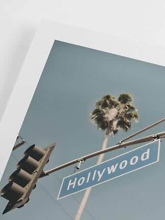 Photo print of Hollywood street sign with traffic light and palm tree against blue sky