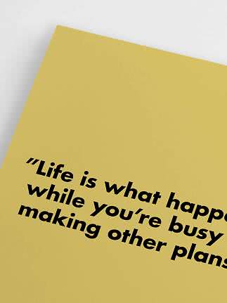 Yellow poster with black quote text, close-up at an angle