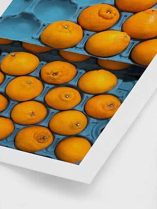 Nahaufnahme von Orangen in einer blauen Kartonschale