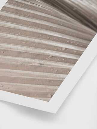Close-up of a beige ribbed surface with water droplets in a white frame