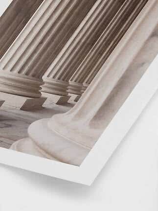 Close-up of classical marble columns in soft beige and gray tones