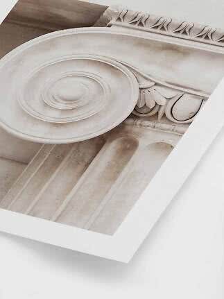 Framed art print showing a close-up of a classical column capital in soft beige tones
