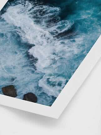 Framed ocean print showing turquoise waves and white foam from above