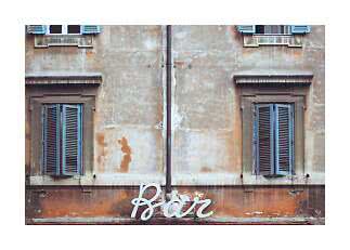 Weathered plaster facade with blue shutters and a white 'Bar' sign at the bottom