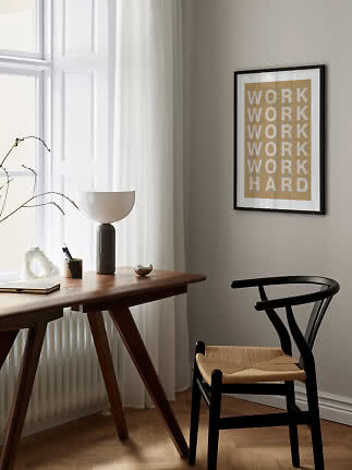 Framed typography poster reading "WORK WORK WORK WORK WORK HARD" above a wooden desk