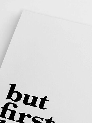Close-up of white poster with black text in the bottom left corner