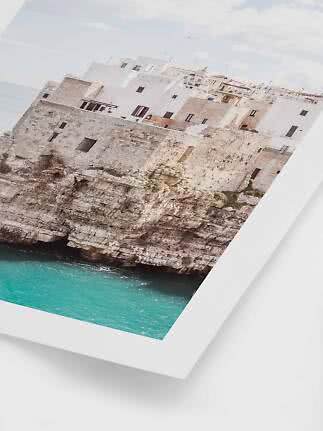 Framed photo of white cliffside houses above turquoise sea