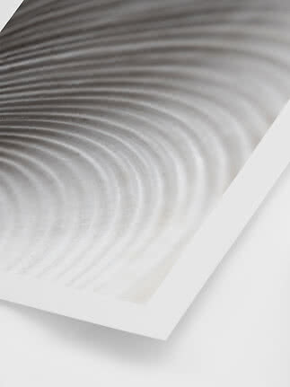Abstract wall art with gray wave pattern in a white frame