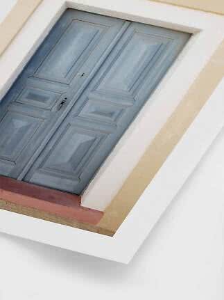 Light blue paneled double door set in a pale facade, viewed from below