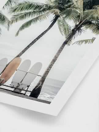 Wall art of palm trees and three surfboards by the beach