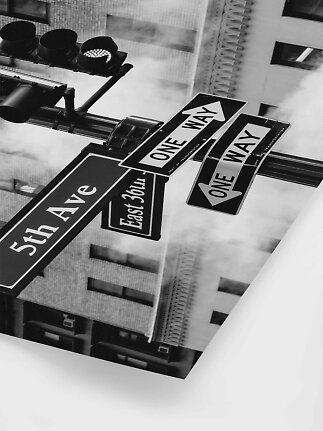 Black-and-white photo of street signs reading One Way, 5th Ave and East 36th St at a traffic light