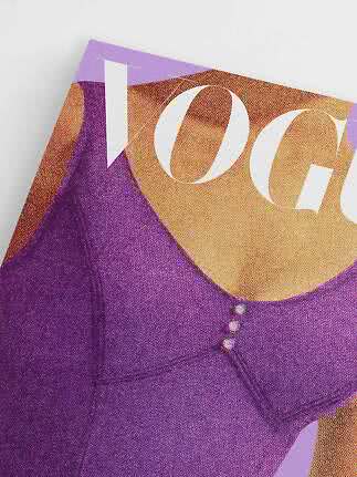 Close-up of Vogue magazine cover with purple top and large white letters