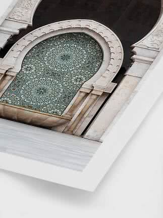 Close-up of arched stone architecture with intricate blue and green geometric mosaic