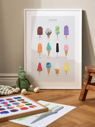Framed children's poster showing colors as different ice creams, leaning on the floor beside a green plush toy