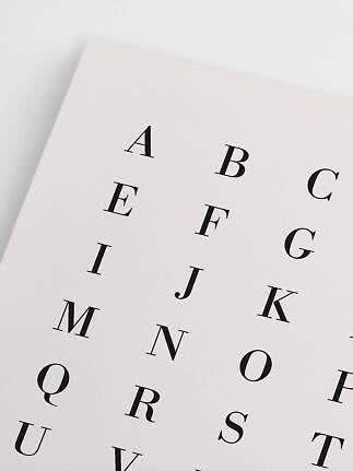 Close-up of alphabet poster with black letters on a cream background