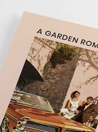 Close-up of poster with vintage car and stylish couple by a stone wall