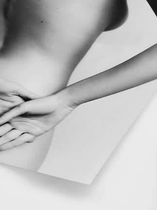 Black-and-white art print with close-up of a person's torso and hand