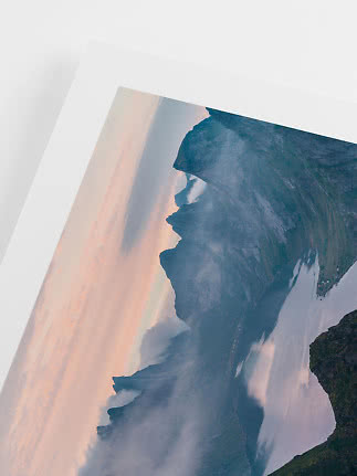 Framed landscape print of misty mountains and fjord in soft pink and blue tones