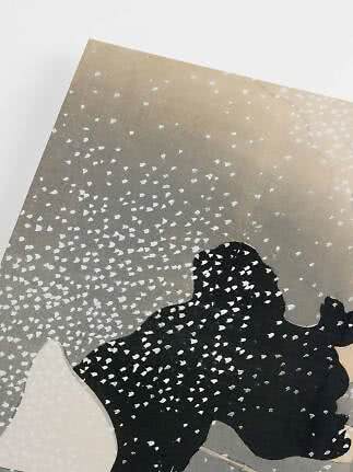 Abstract print with black organic shape and white speckles on a gray and beige background