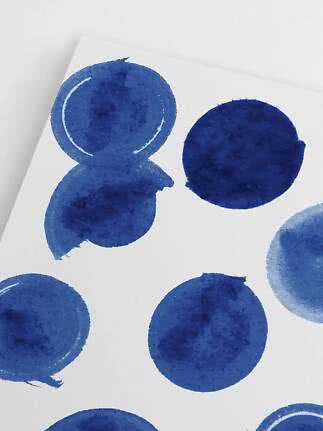Close-up of white paper with hand-painted blue watercolor circles