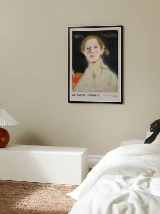 Lámina artística enmarcada con retrato en pared beige sobre banco blanco junto a la cama