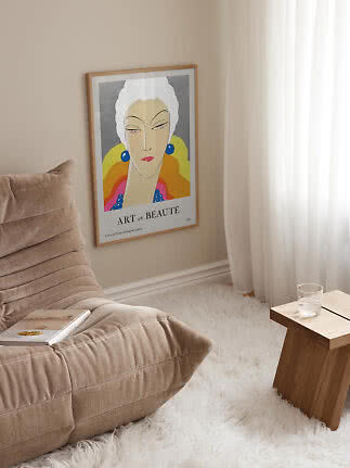 Framed Art et Beauté poster with stylized woman portrait on beige living room wall