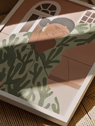 Framed illustration of a woman in a green patterned dress applying cream to her cheek