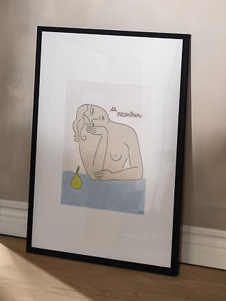Framed art print with abstract female figure and green pear on a light blue surface