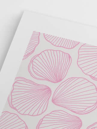 White sheet of paper with a light pink seashell pattern