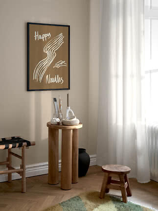 Gerahmtes braunes Poster mit weißer Nudelillustration und dem Text „Happy Noodles“ an der Wand.