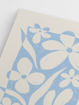 Close-up of white fabric or paper with a light blue floral print