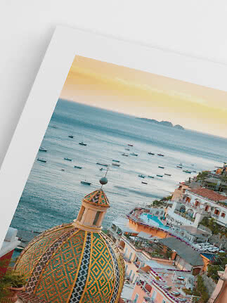 Framed coastal photo with tiled dome, sea, boats and town at sunset