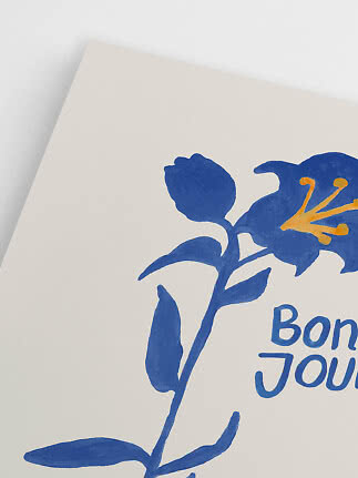 Close-up of poster with blue flower, yellow center and partial text on a light background