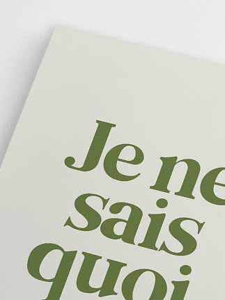 Close-up of poster with large green typography on a cream background