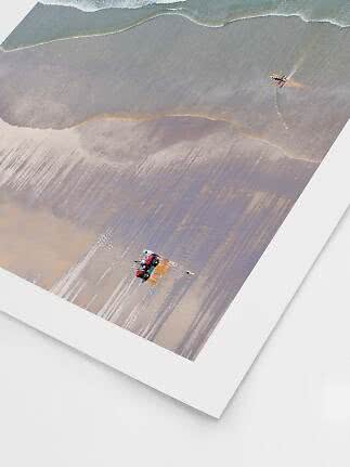 Poster with aerial beach scene showing waves, a red tractor and a small red airplane