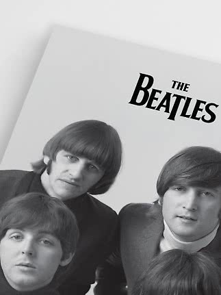 Black-and-white poster of The Beatles with the band name at the top