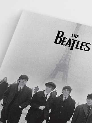 Black-and-white poster of The Beatles in front of the Eiffel Tower in fog