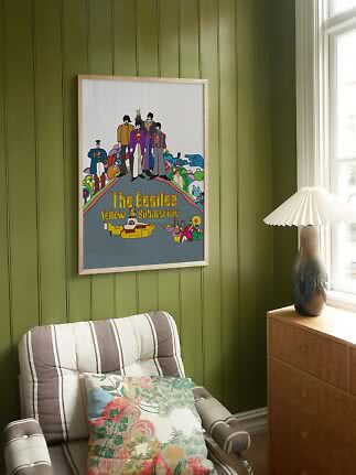 Affiche encadrée The Beatles Yellow Submarine sur mur à panneaux verts, près d’un fauteuil et d’une lampe