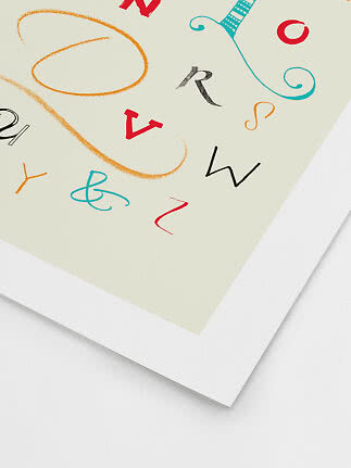Close-up of art print with colorful letters and abstract swirling shapes on a light background