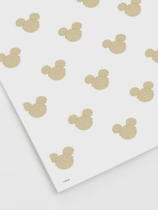 Weißes Blatt mit sich wiederholendem Muster aus kleinen goldenen Mickey-Köpfen