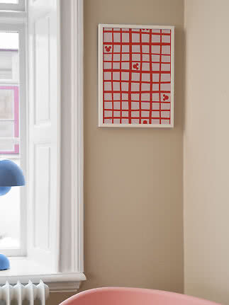 Gerahmtes abstraktes Poster mit rotem Gittermuster an beiger Wand