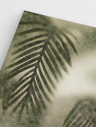 Close-up of the two palm fronds behind the frosted surface, where the nearer leaf stays green and the far one dissolves